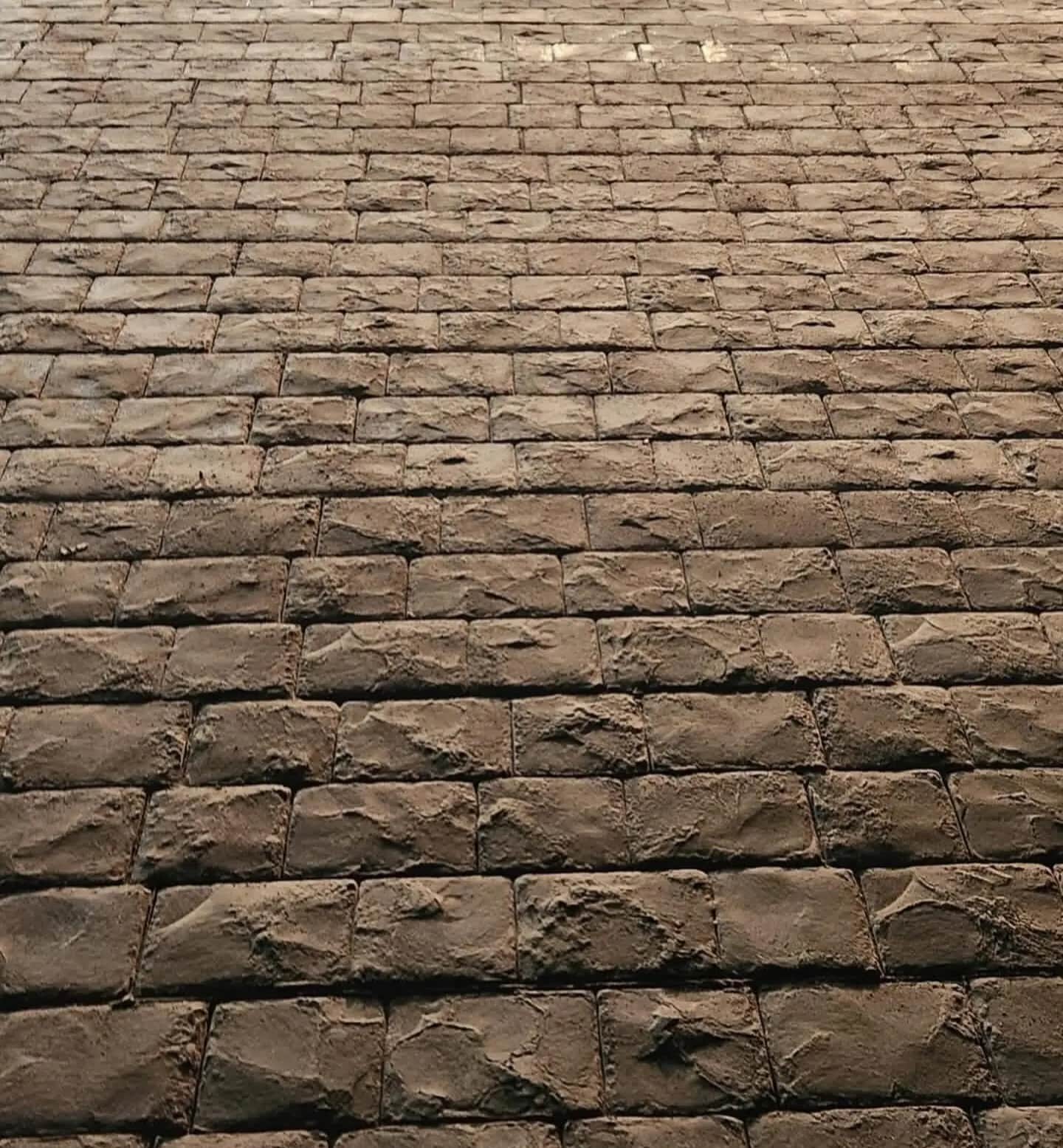 Detailed view of a custom stamped cobblestone concrete surface